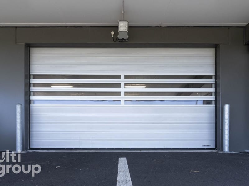 Ulti Spiral Door installed at an airport facility with vision panels.